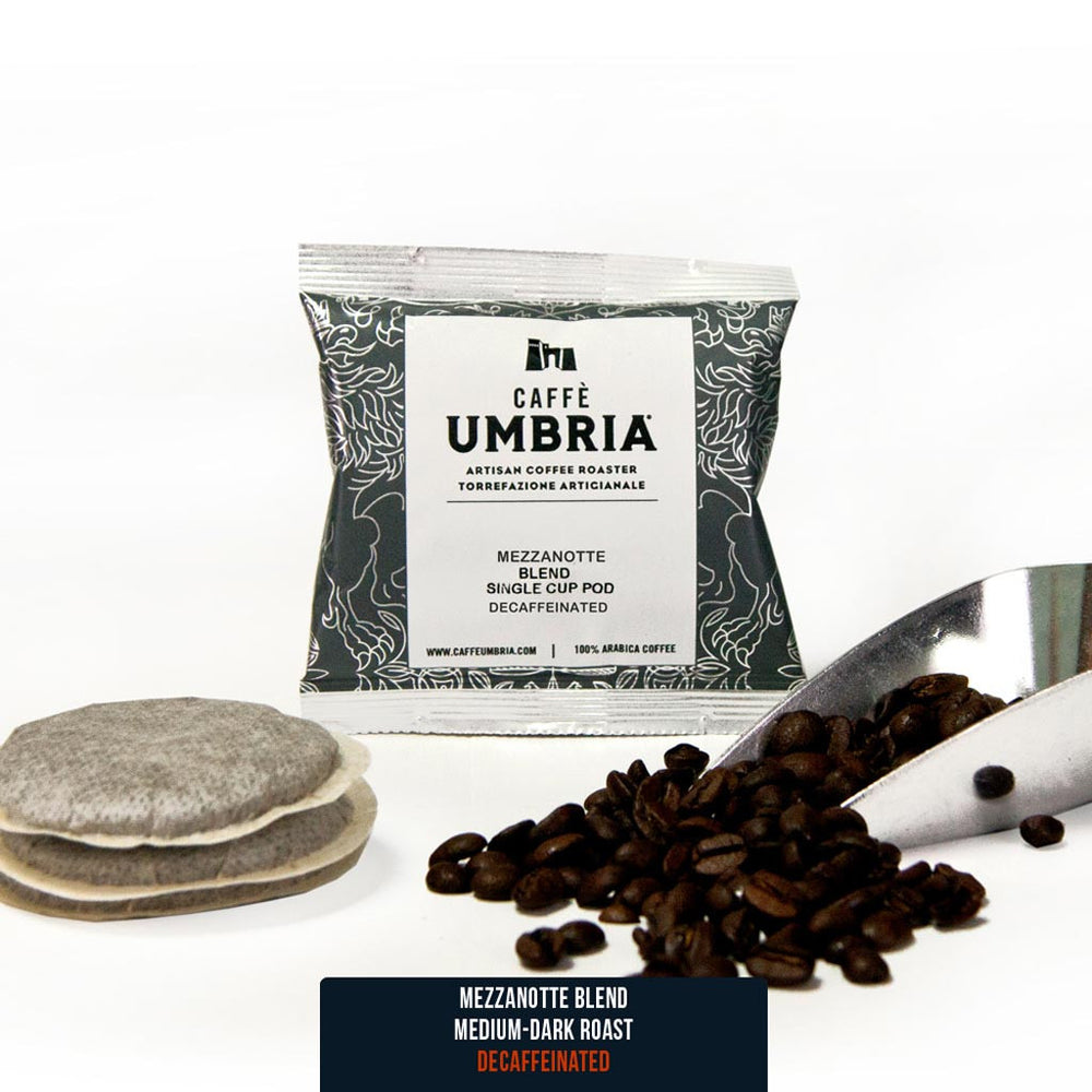 two single serve coffee pods, coffee beans and coffee scoop and blue pod pouch