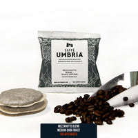 two single serve coffee pods, coffee beans and coffee scoop and blue pod pouch