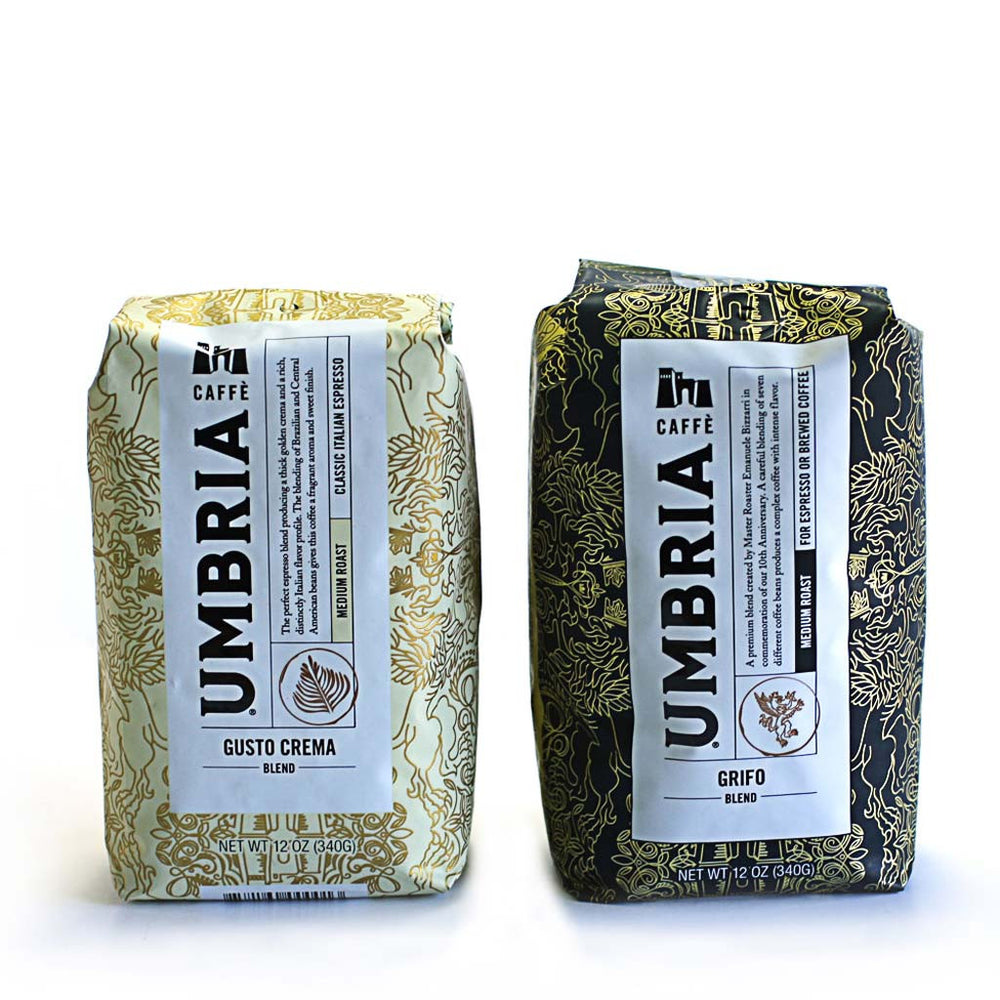 a cream bag of coffee and black bag of coffee on white background